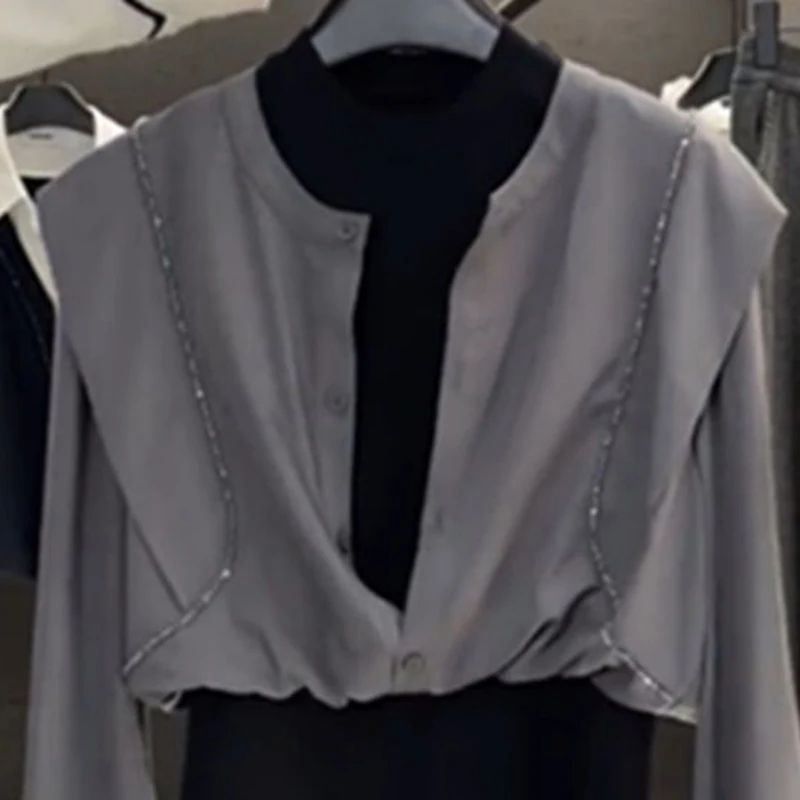 Fake two-piece long-sleeved shirt female summer design sense niche stitching retro temperament Joker fashion slim top.