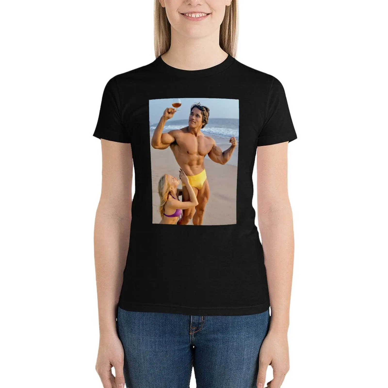 Arnold Schwarzenegger posing with lady on the beach in the 70s T-Shirt Female clothing hippie clothes western t shirts for Women