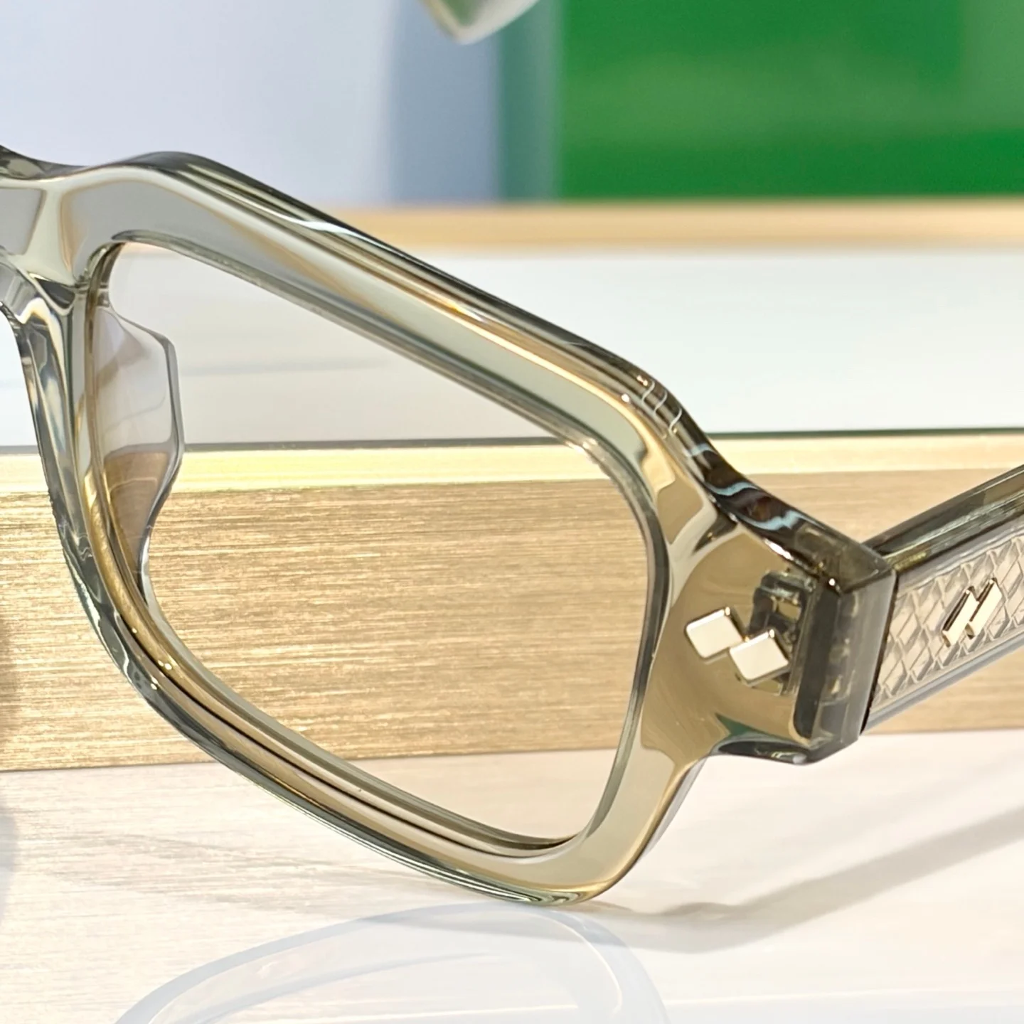 1442S Sunglasses. Translucent olive frame, metal accents. Light UV lenses. Retro style upgrades your daily look.