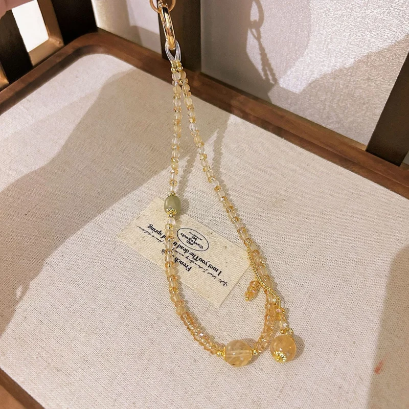 

Natural yellow crystal phone lanyard for women, short wrist strap with crystal chips, anti-lost phone chain accessory