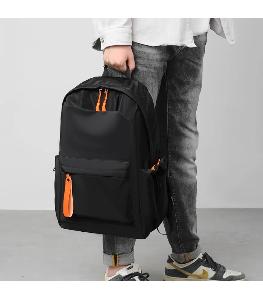 Shiny black casual backpack with orange fabric pull tabs anti splash lightweight waterproof fabric for teen school outdoor daily