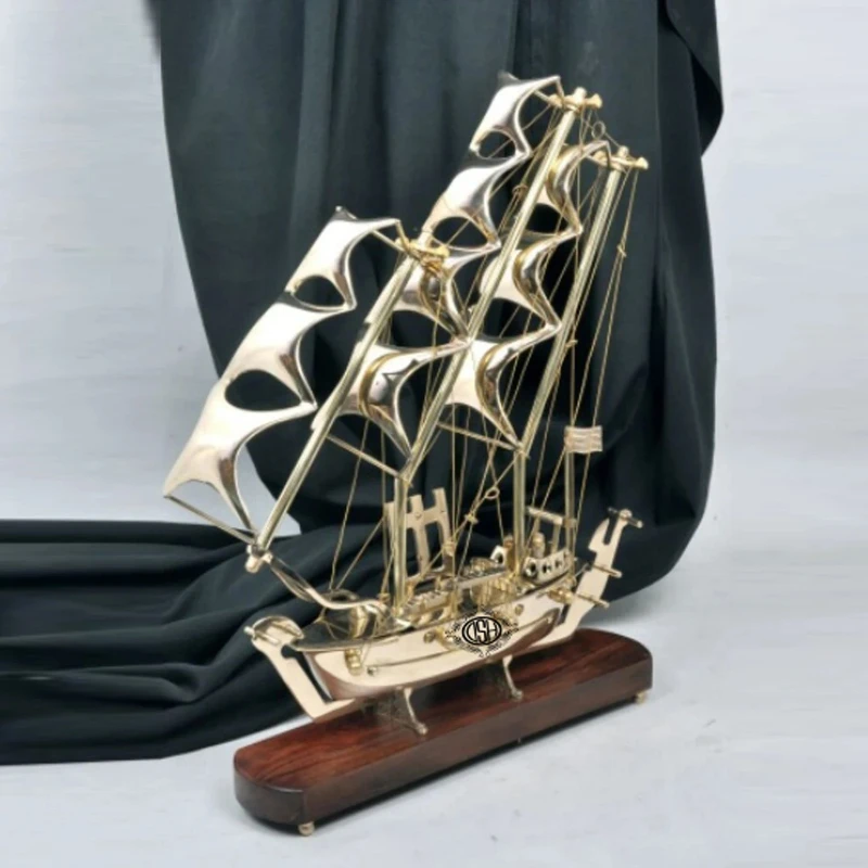 

Brass boat with wooden base, ideal for home decoration displays.