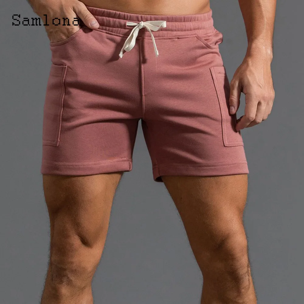 2025 ฤดูร้อนใหม่กางเกงขาสั้นสบายๆผู้ชายเซ็กซี่เอวยางยืดกางเกงขาสั้นชายขาตั้งกระเป๋าฟิตเนสชายหาดสั้นกางเกงสีเทาสีขาว