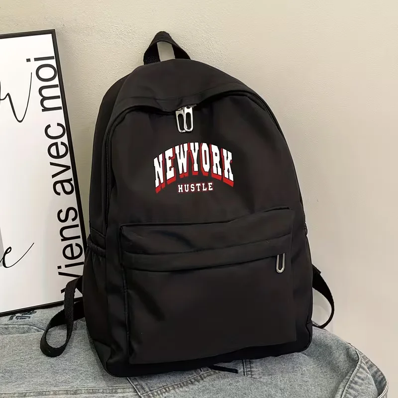 A large-capacity, casual, and versatile backpack perfect for back-to-school season, featuring a simple New York logo print. It's