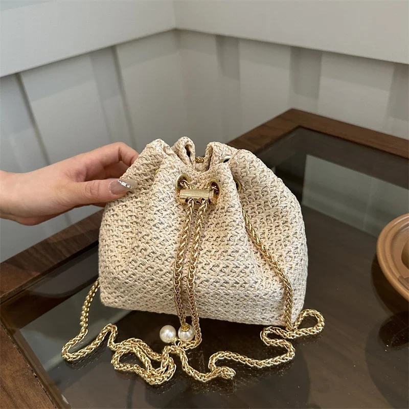 Grass woven small bag female bucket bag spring/summer 2024 new western style belt chain minority trend messenger women straw bag