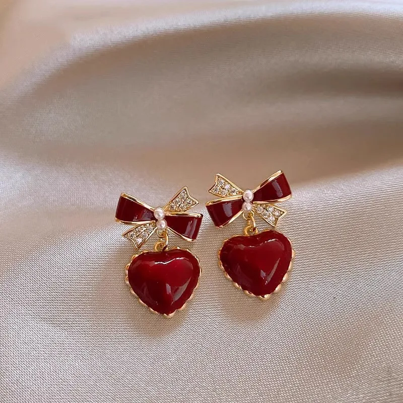

Affordable promotion bow peach heart earrings for women, niche, mature, stable temperament, red ear buckle