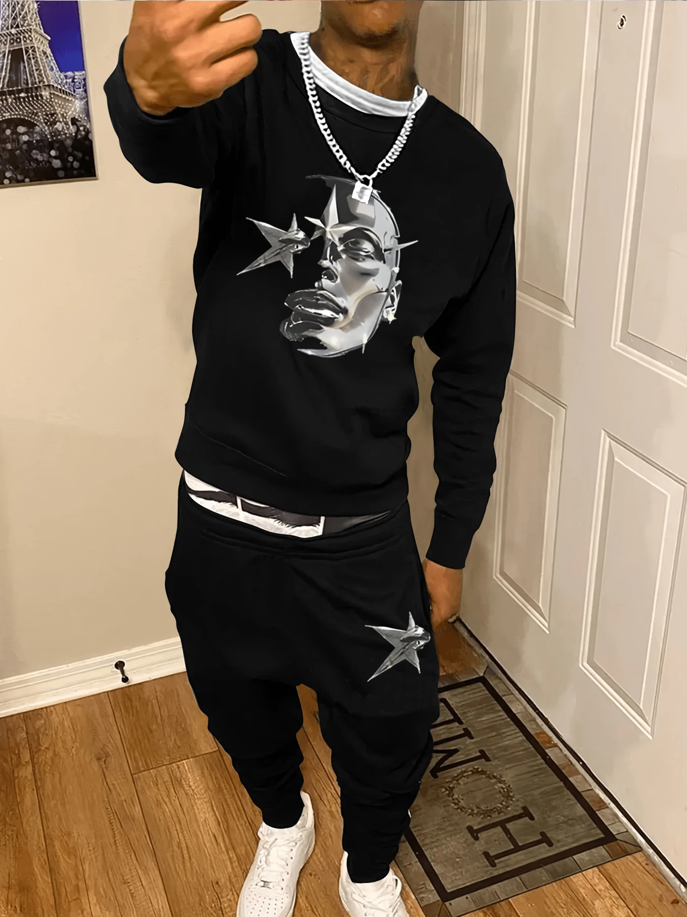 

Round neck sweatshirt suit. Abstract character face with silver metallic texture. The overall style is cool