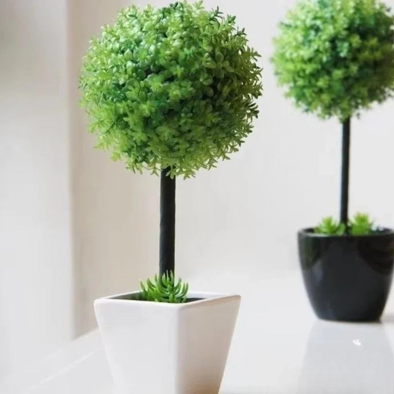 

High simulated beautiful table decorated with artificial boxwood grass ball bonsai