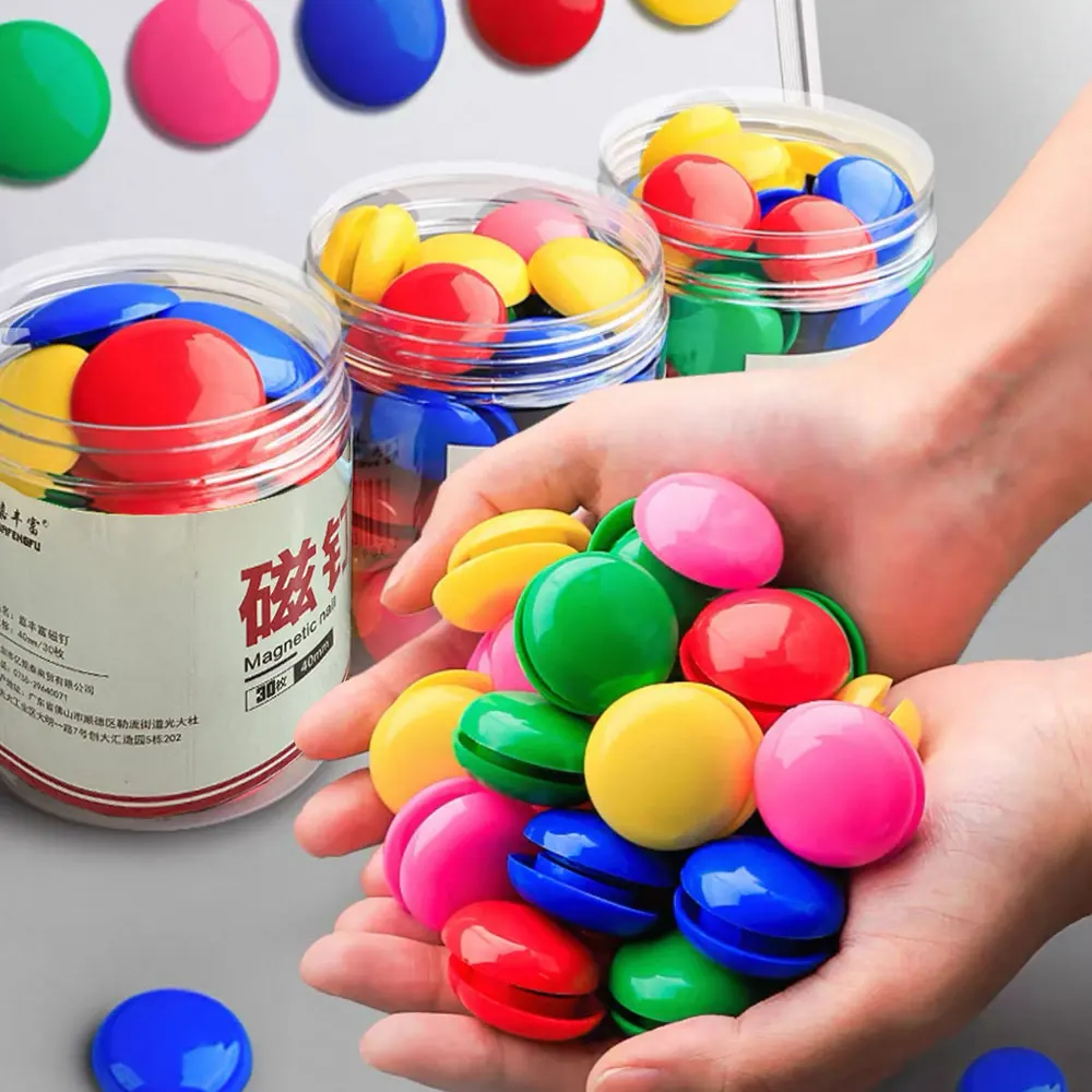 Bucket of colorful round magnets, fridge magnets, wall paper holders, black and white board magnets.