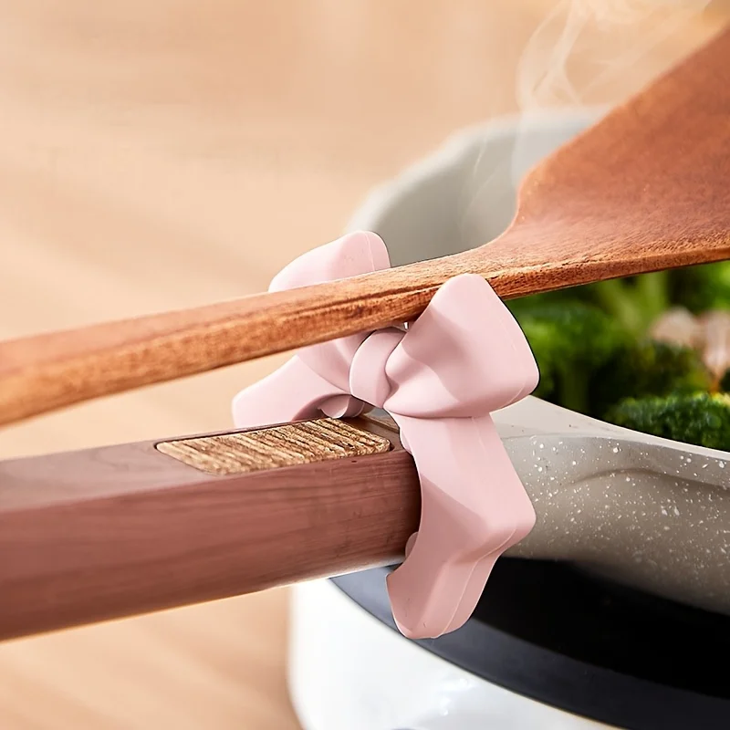 1 Stück Silikon-Spatelhalter mit Schleifen-Design, auslaufsicherer Schöpfkellenständer für die Küche, Platzierungsregal für Utensilien, bewegliches Lagerregal