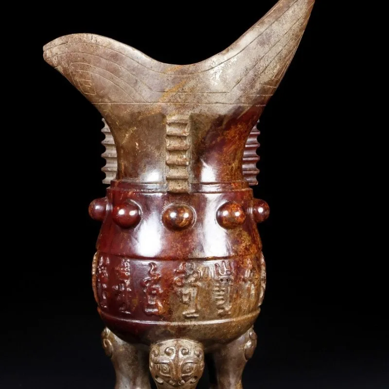 

The three-legged cup weighs 938.5 grams, is 21.5 cm high, 14.4 cm wide, and is 10.2 cm thick.