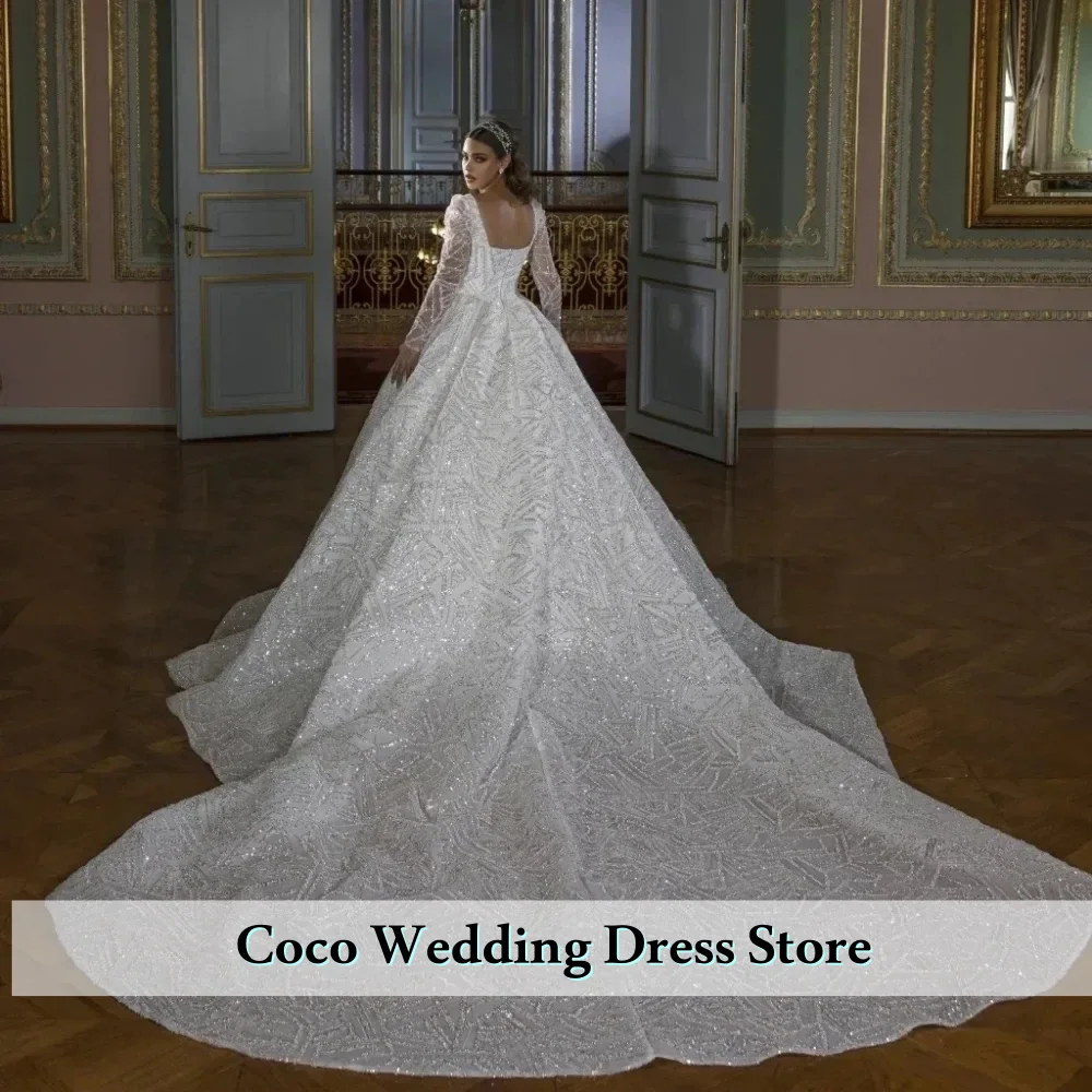 فستان زفاف رائع مخصص برقبة مربعة مزين بالترتر اللامع وأكمام طويلة فستان العروس فيستدو دي نوفيا