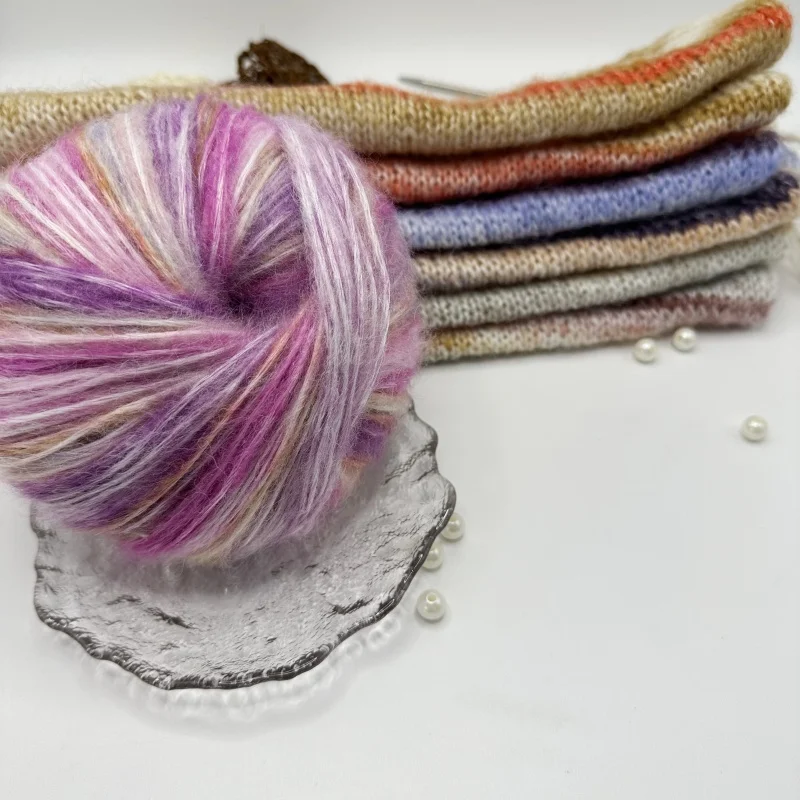 The yarn is a gradient wool-mohair blend with a rainbow segment-dyed medium weight. Each ball weighs 100 grams and is 350 meters