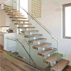 Single spine stringer stairs with 12mm frameless glazed balustrades and Flat bar handrails