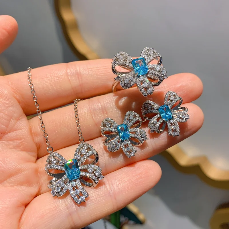 

Blue Topaz Bowknot Bone Chain Necklace for Women, Simple Blue Stud Earrings and Ring Jewelry Set Wholesale