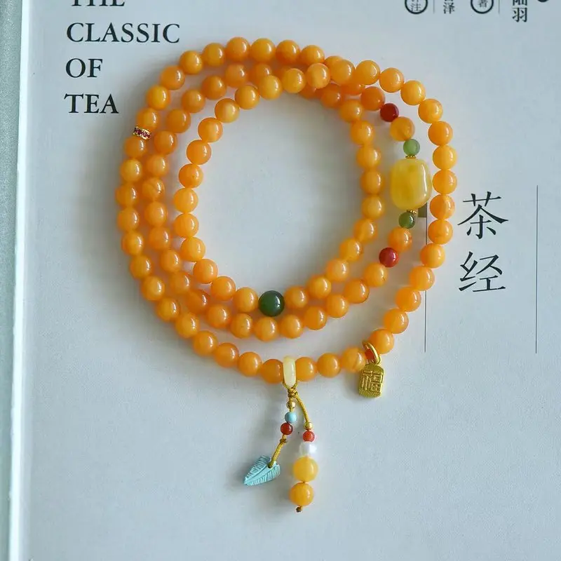 Natural old amber bracelet three strands featuring a full honey color and a mythical flower design paired with Sout