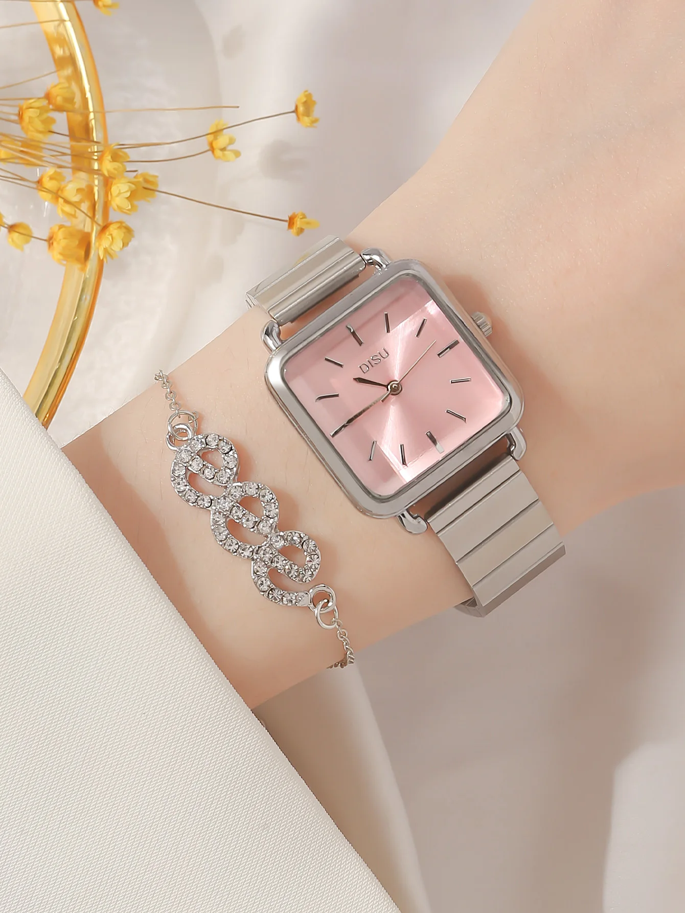 A Women\'s Pink Classic Fashion Small Square Stainless Steel Watch With Quartz Strap And A Rhinestone Bracelet