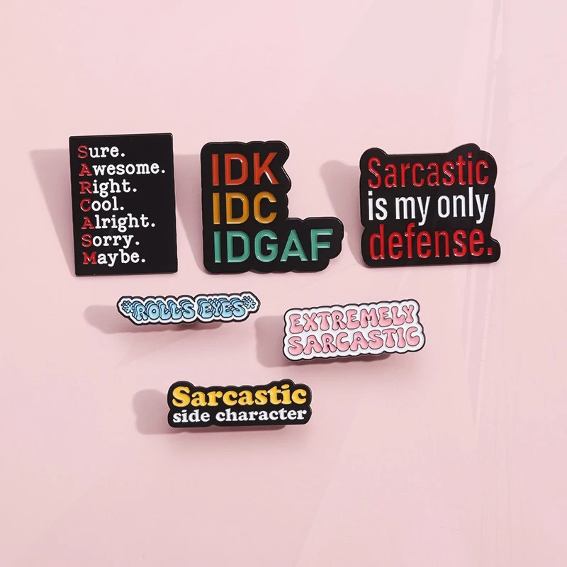 Pin de metal con letras en inglés