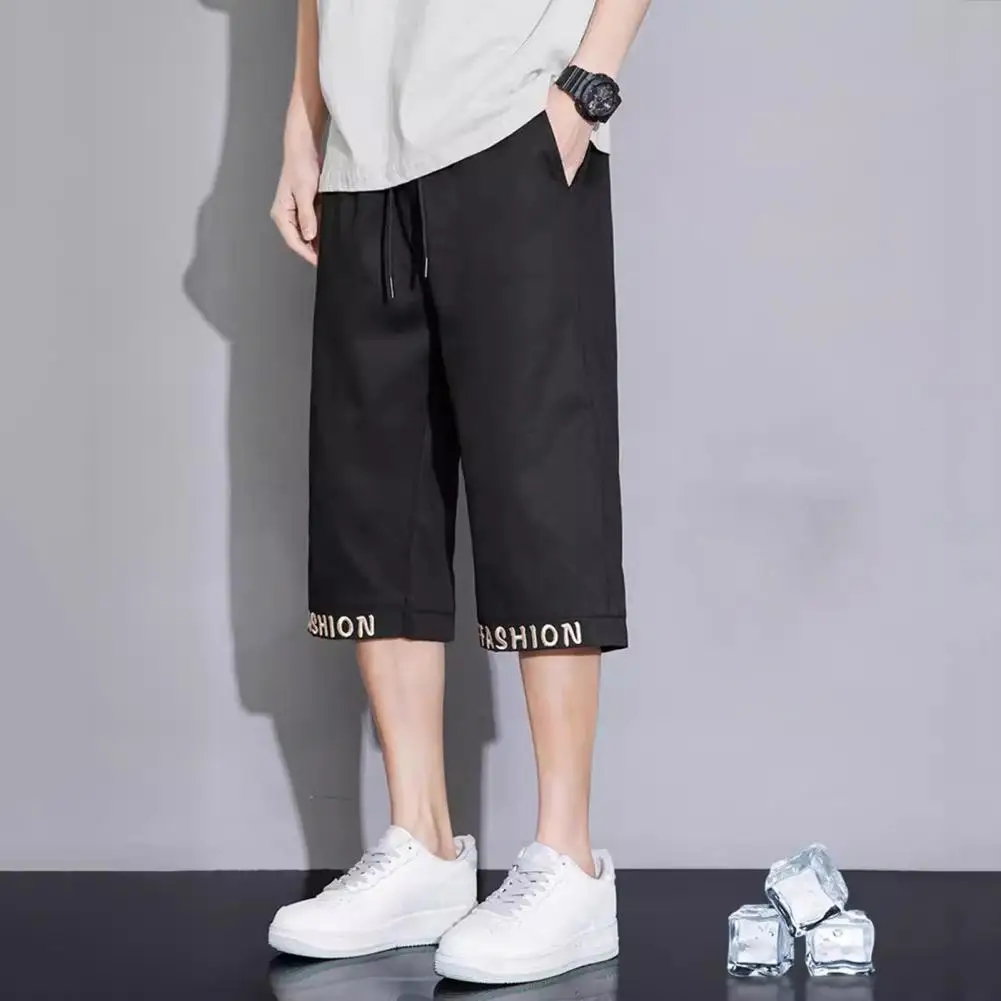 

Zippered Pocket Trousers Stylish Men's Cropped Pants with Elastic Waistband Adjustable Drawstring Featuring Letter for Casual