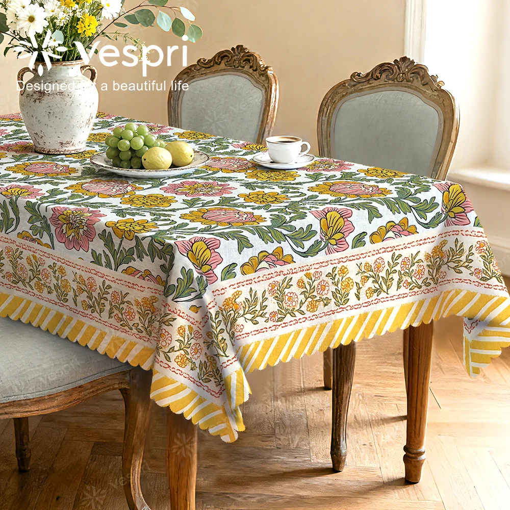 Vespri Spring Tablecloth, with white and yellow decorations, featuring flowers and green leaves