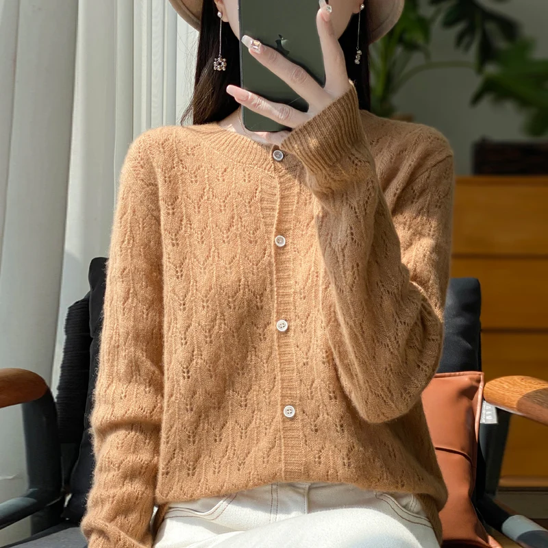 Autumn and winter new 100% pure wool cardigan female O-neck hollow crocheted solid color long sleeve sweater loose sweater coat.