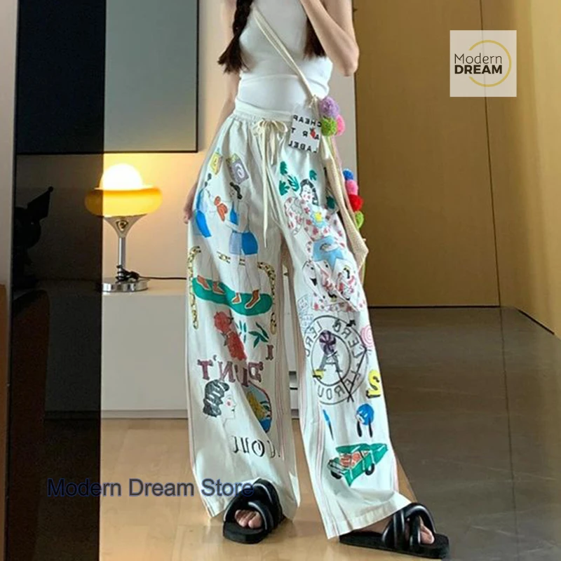 Korean version of simple minority cartoon graffiti printed pants women's summer new plus size design high waist casual pants.