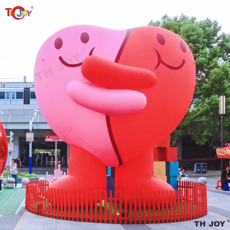 Giant Inflatable Pink Cartoon hug together with red Heart for Valentine's Day