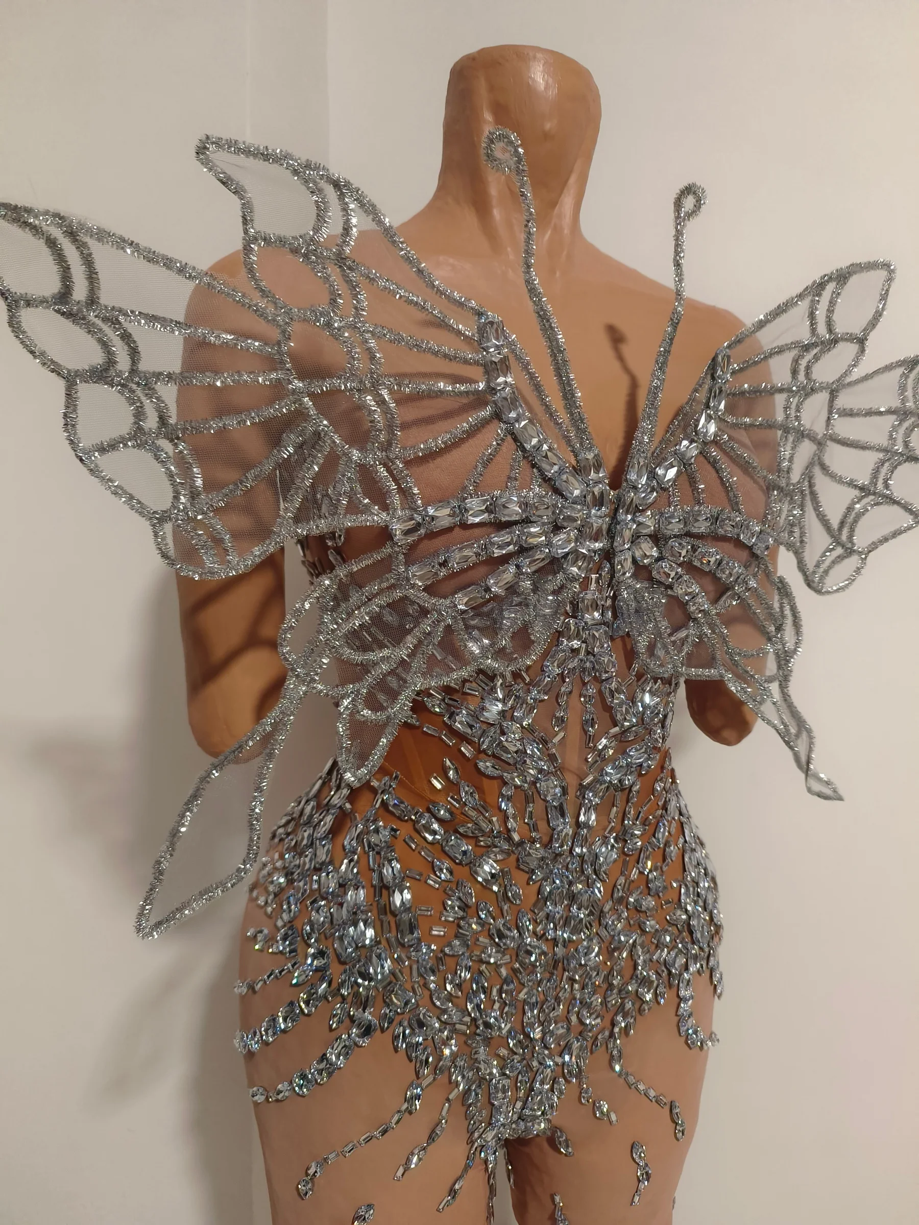 

Diexian Nude Base Sheer Mesh Bodysuit with Silver Rhinestone Butterfly Pattern and Statement Wings for Cabaret and Stage Shows