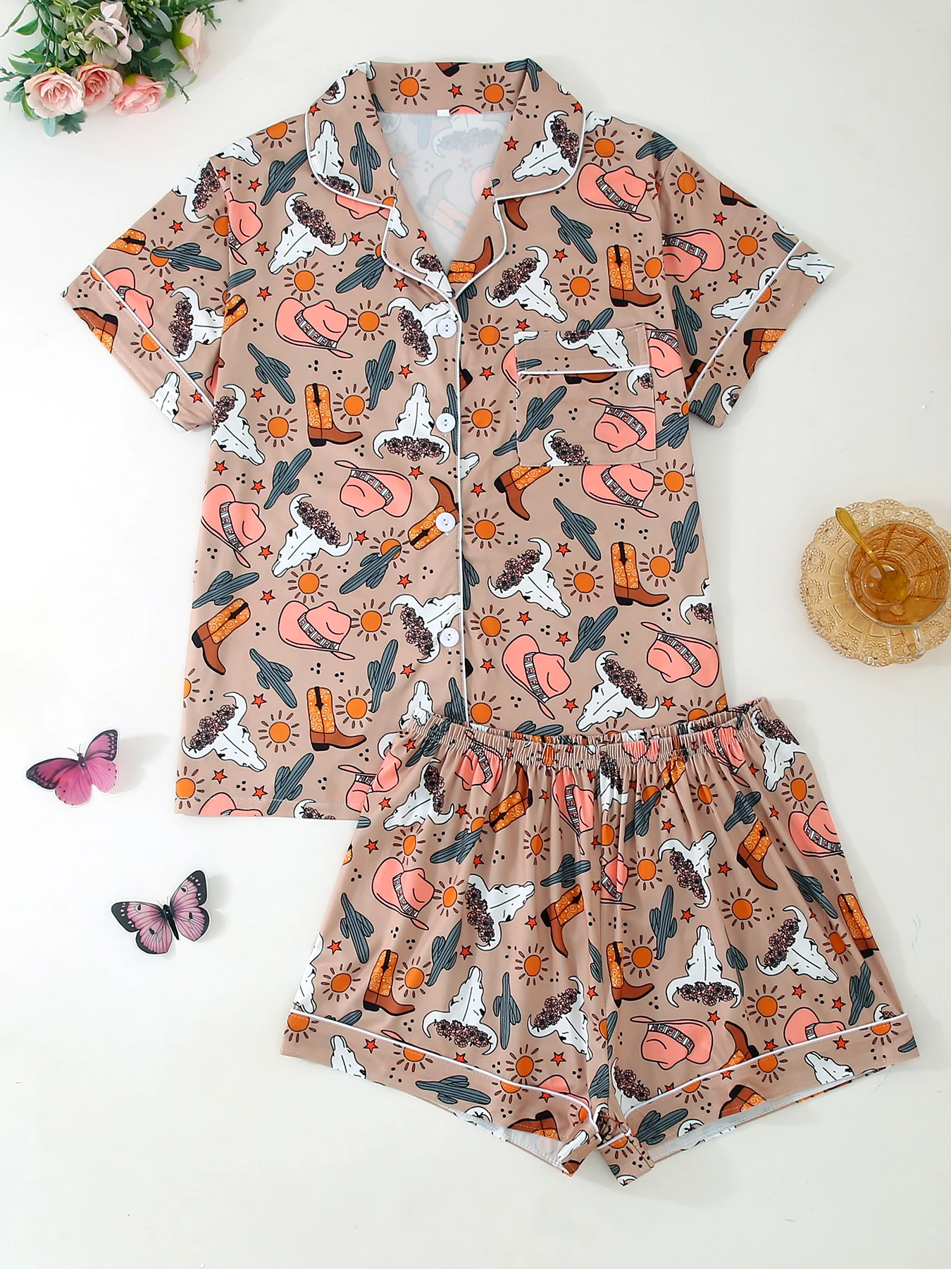 

Two - piece pajamas set, cowboy - style, featuring a short - sleeved button - front shirt with a notched collar and loose, stret