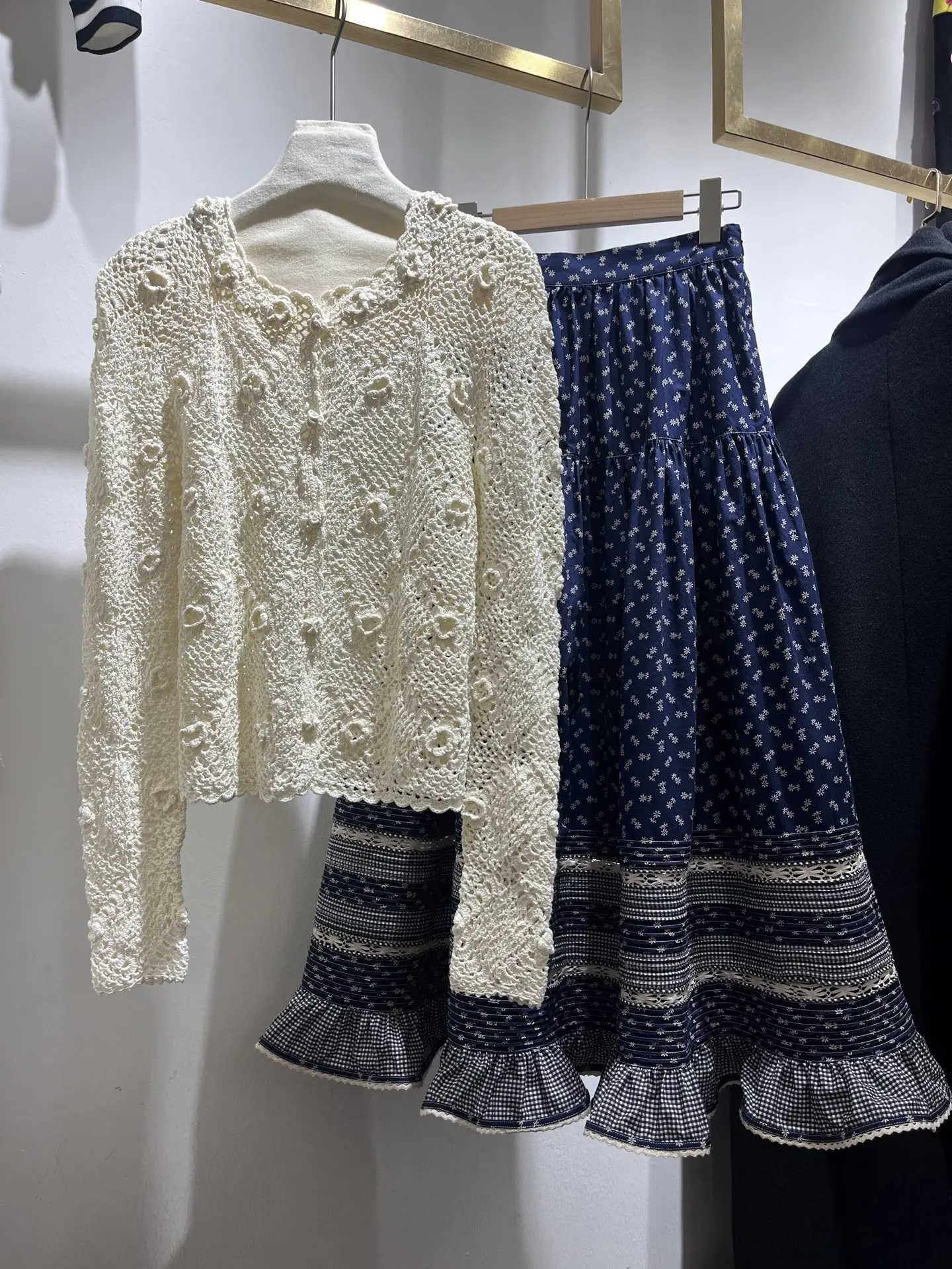 

Women Hook Flower Hollow Round Neck Long Sleeve Single Breasted Knitted Cardigan + Floral Printed High Waist Long Skirt Suits