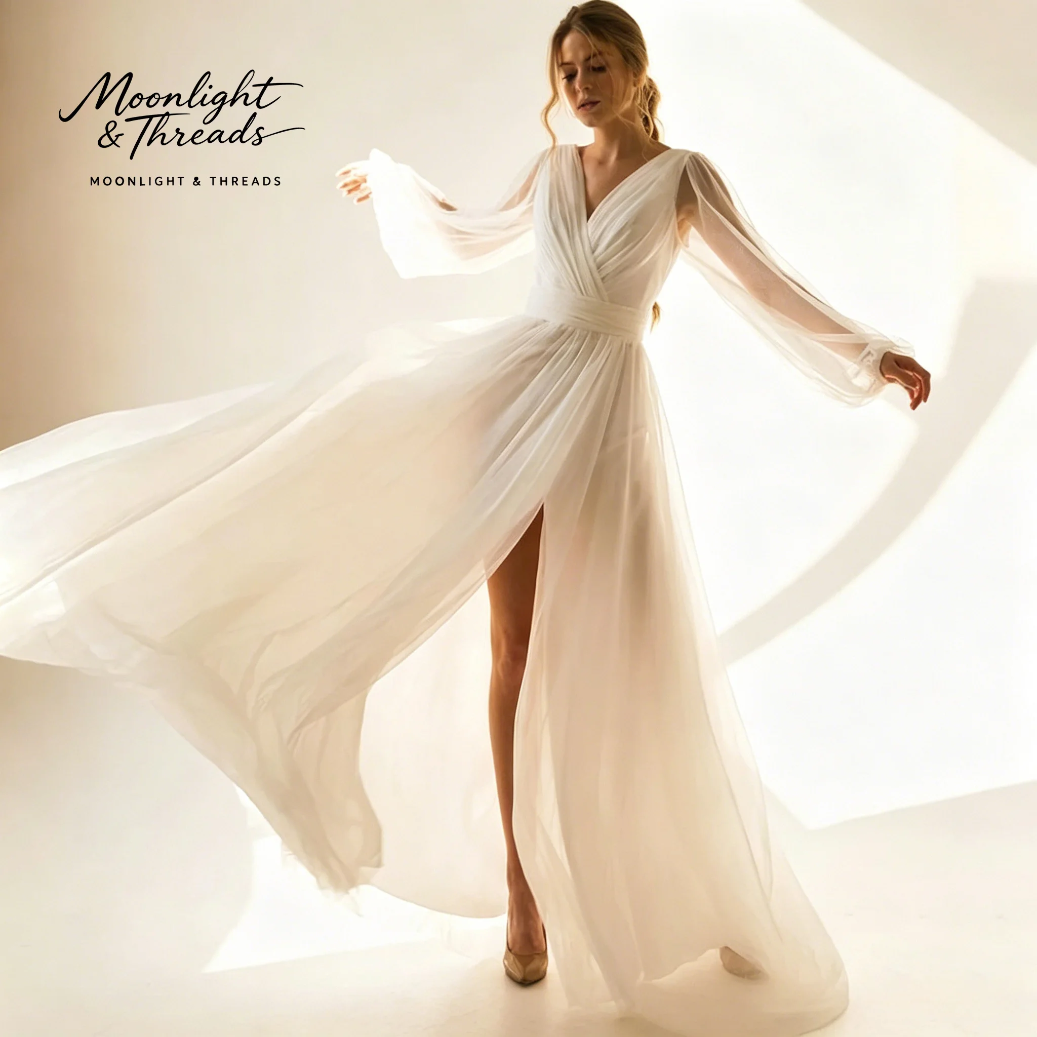 

Elegant ivory V-neck long-sleeved floor-length formal gown featuring a tulle skirt with a slit perfect for weddings