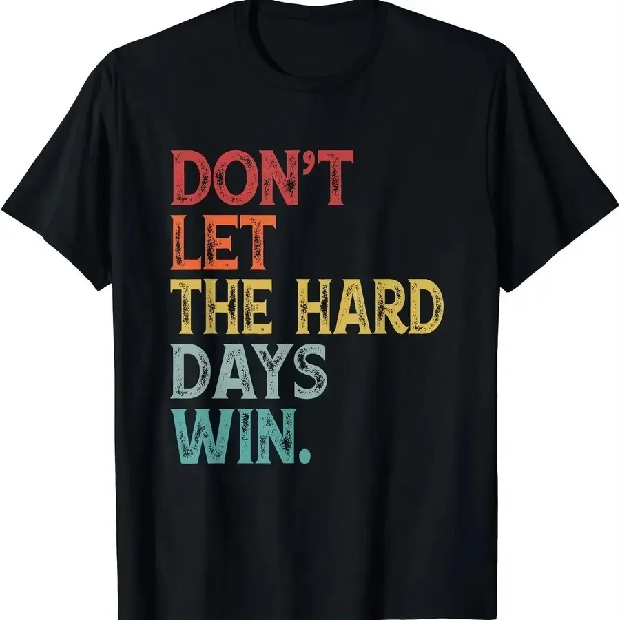 Camiseta motivacional unisex con estampado de letras en bloques de colores vibrantes, negra con detalles en rojo, amarillo, azul y verde azulado, de Don't Let The Hard Days Win