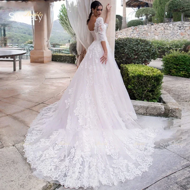 Robe de mariée trapèze chic glamour avec dentelle brodée, robe de Rhen organza, demi-manches, col rond, dos à lacets, mariée