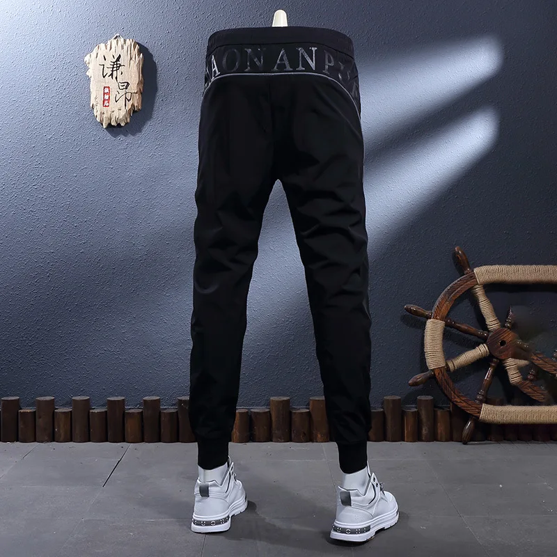 

Summer thin ice silk cool and breathable letter printed elastic slim fit small foot binding casual sports pants for men
