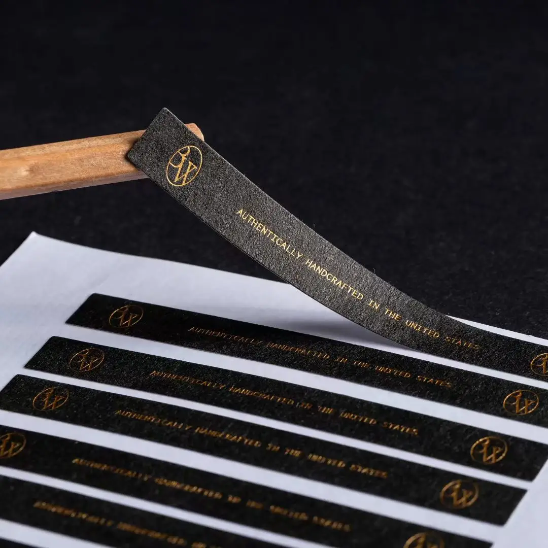 Luxury Packaging Label: Custom Textured Paper Sticker with Gold Foil Stamped Black Logo