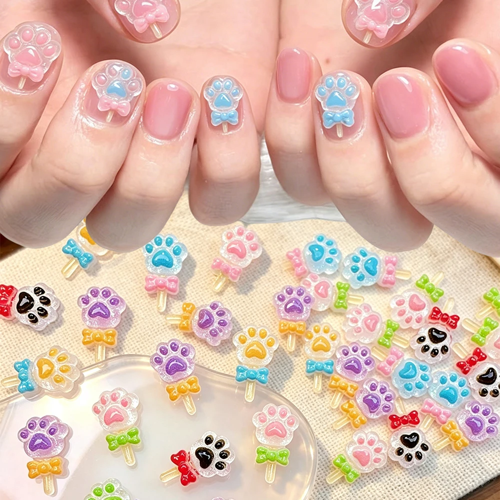 50 Stück gemischte Farben Lollipop-Pfoten-Nagelcharms, transparente Glitzer-Schleifen, 3D-Flachback-Nageldekorationen für DIY-Maniküre-Nagelzubehör