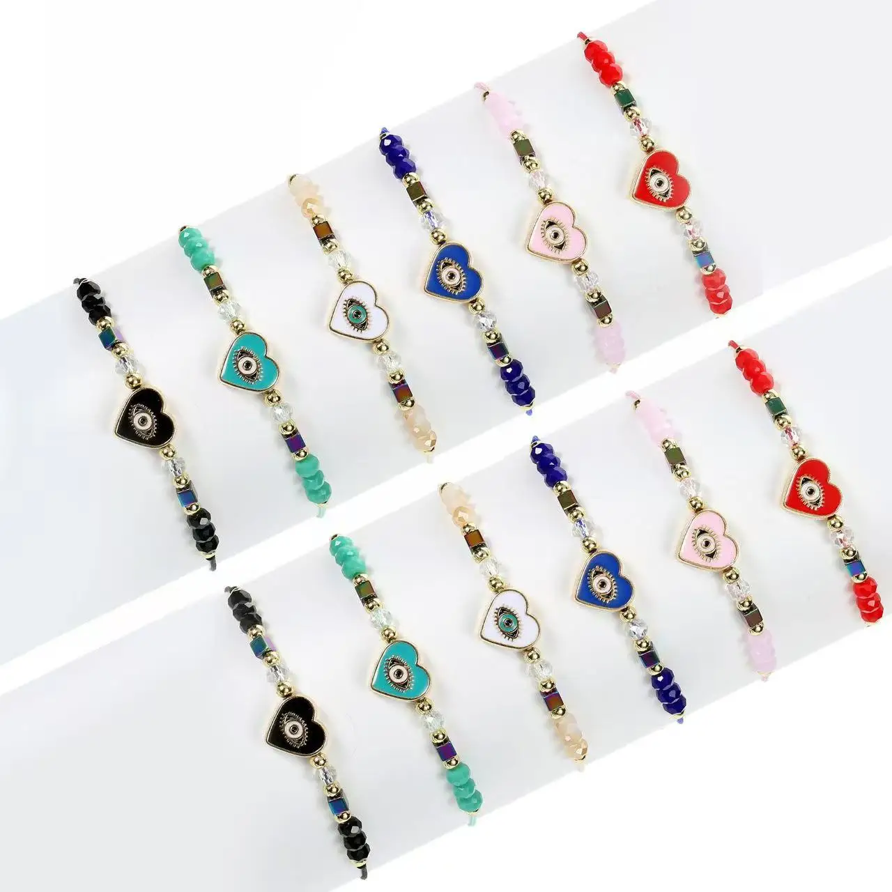 Un juego de 12 piezas de pulsera ajustable de moda europea y americana tejida con cristales de mal de ojo y corazón que gotea aceite