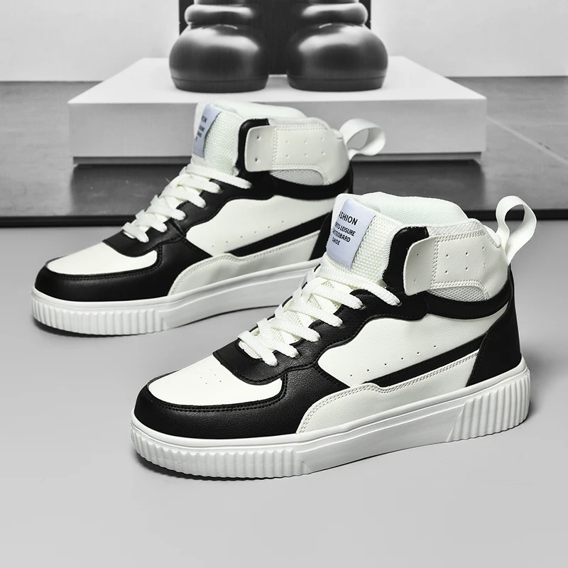 Black and white high-top sneakers on a gray surface with a blurred background