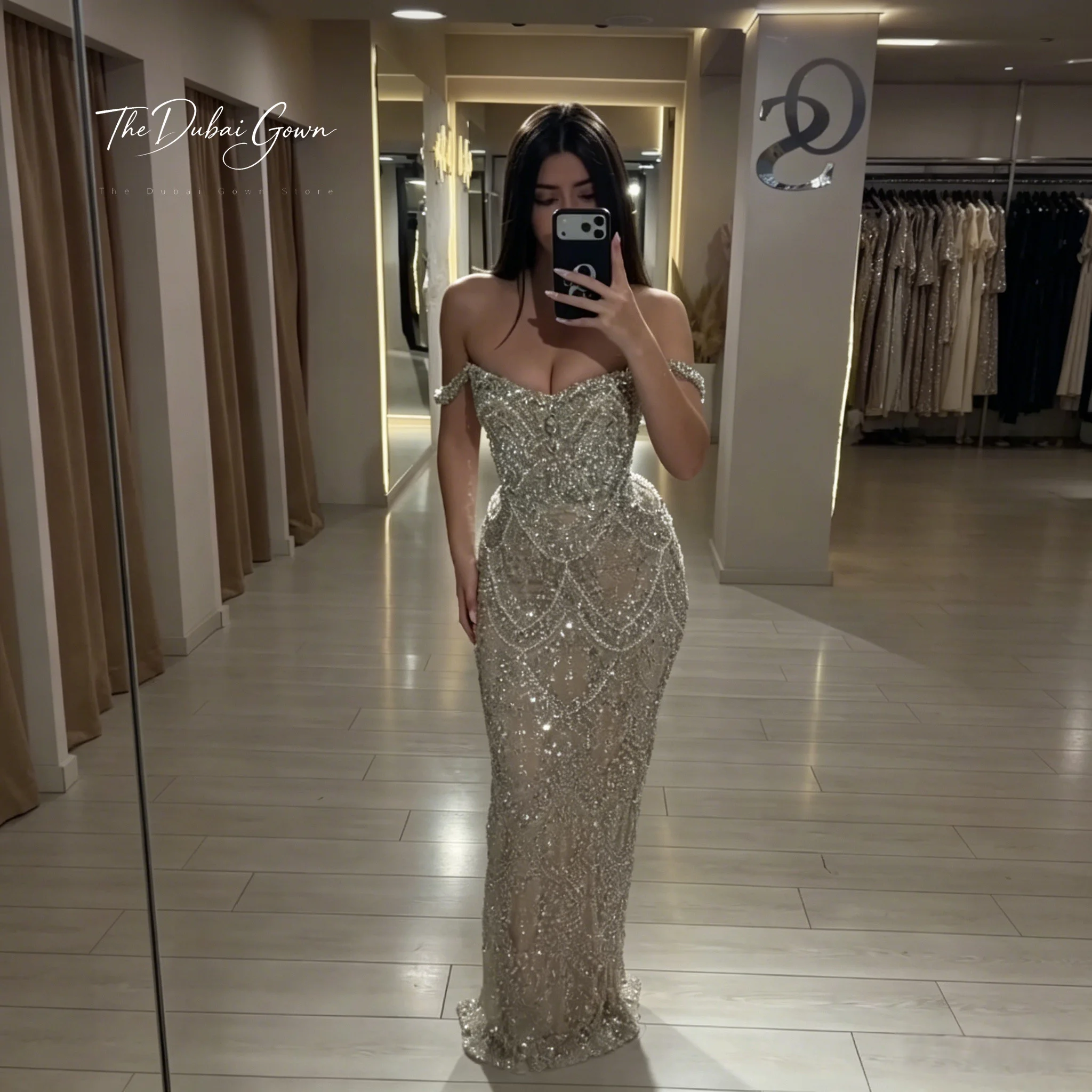 Glamorous silver off-the-shoulder strapless floor-length mermaid formal gown with beaded crystal embellishments