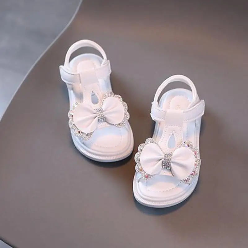 Sandal Anak Perempuan Musim Panas Sepatu Anak Perempuan Bayi Berlian Imitasi Pita Imut Sepatu Putri Hak Datar Lembut Mode Sandal Pantai Anak-anak Pink H140