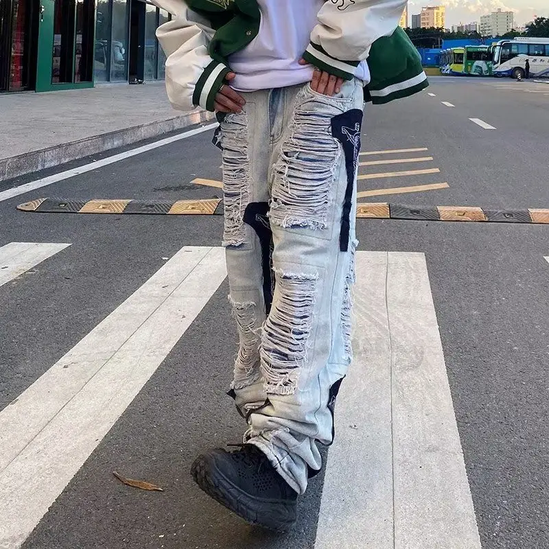 High Street Hip Hop Cuciture strappate Jeans decostruiti Design Sense Pantaloni a gamba dritta con toppa vintage Uomo Donna