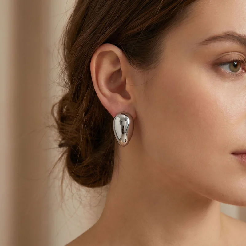 CarlidanaEuropean and American style versatile simple three-dimensional water drop earrings in titanium steel with a niche high-