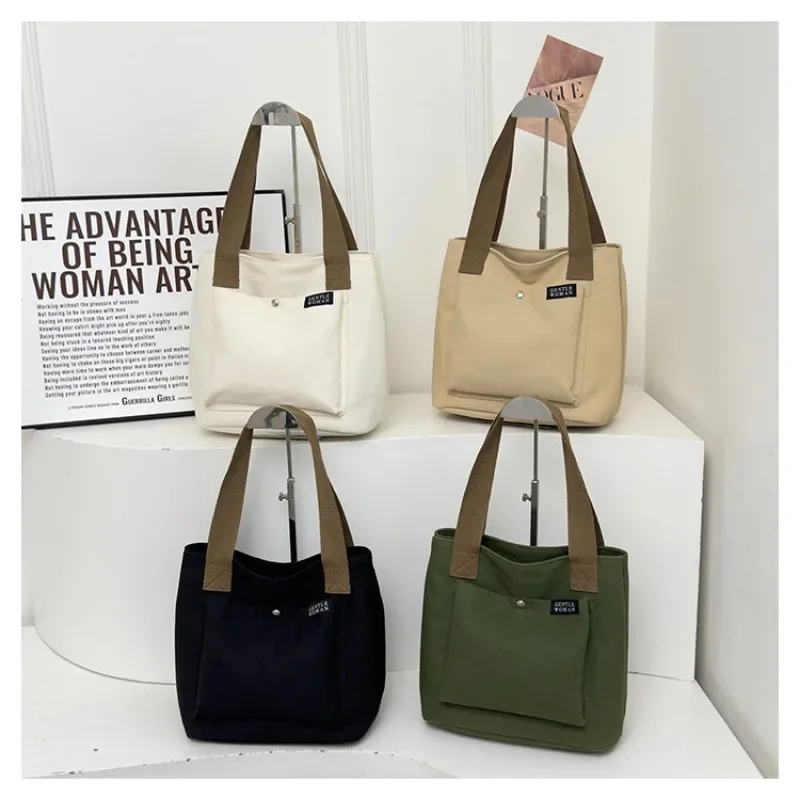 2025 جديد قماش بسيط سستة المرأة مصمم حقيبة يد شعبية بلون العصرية سستة عادية حسن المظهر حقيبة كتف