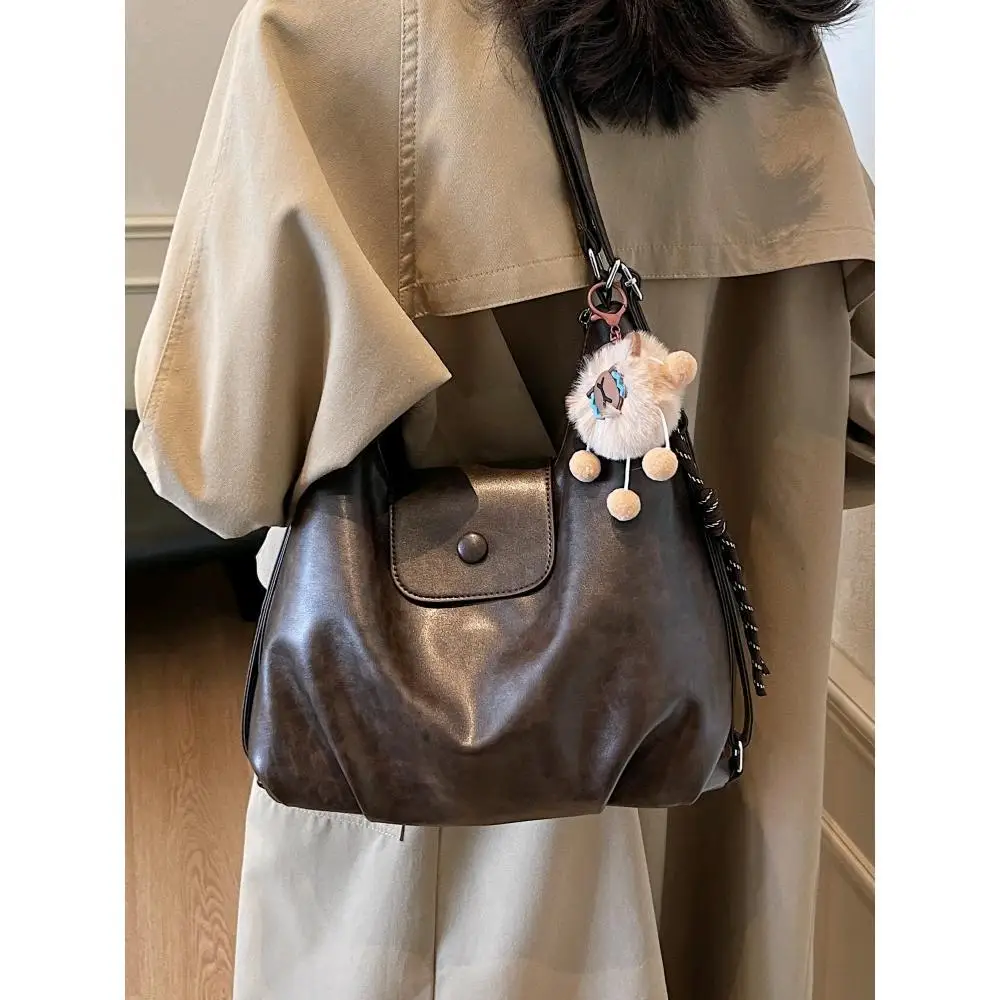 

Vintage Large Capacity Shoulder Bag with Cute Fur Ball Dolphin Pendant for Commuting Backpack Handbag