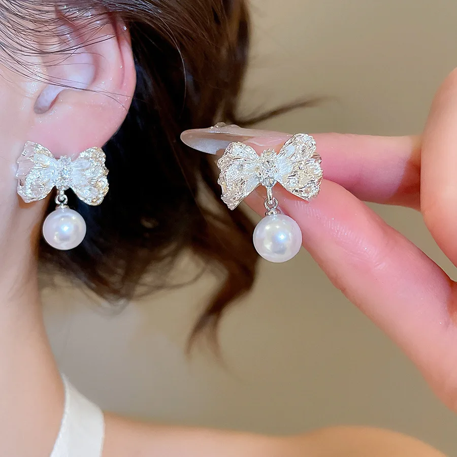 Ruffled bow pearl earrings