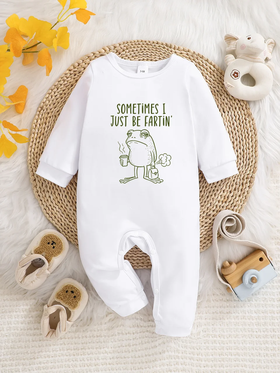 A baby long-sleeved onesie with interesting letter prints. It features a buttoned design for easy putting on and taking off, and
