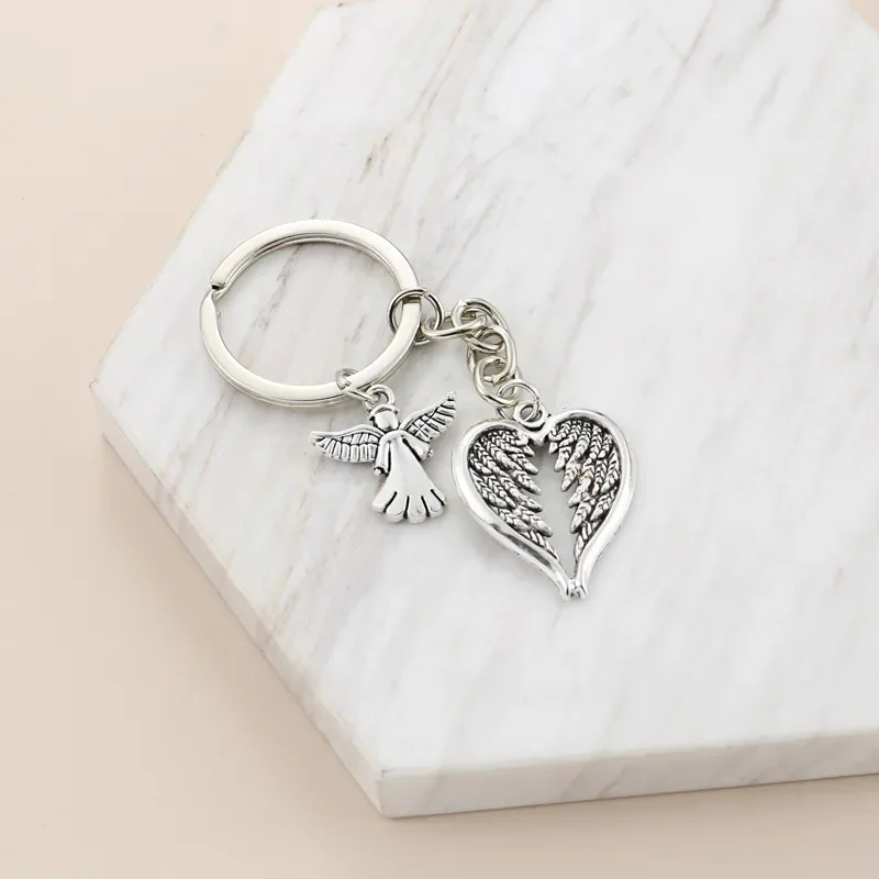 سلسلة مفاتيح Fashion Guardian Angel بتصميم أجنحة على شكل قلب، خفيفة وذكية، يمكن تعليقها على حقائب اليد