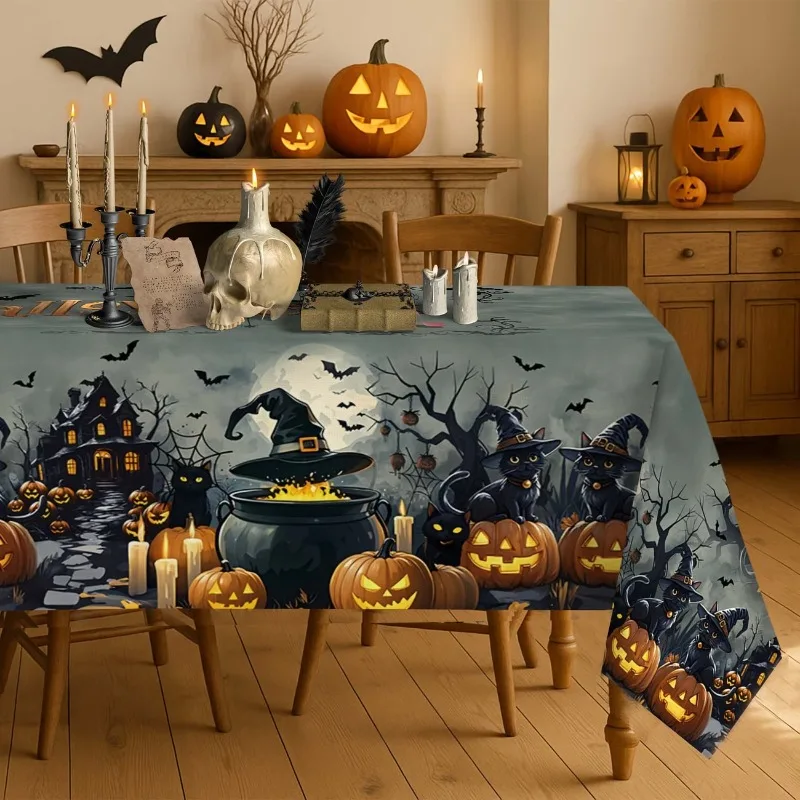 A vintage Halloween tablecloth - with ghosts, castles, bats, black cats, pumpkins and haunted houses -
