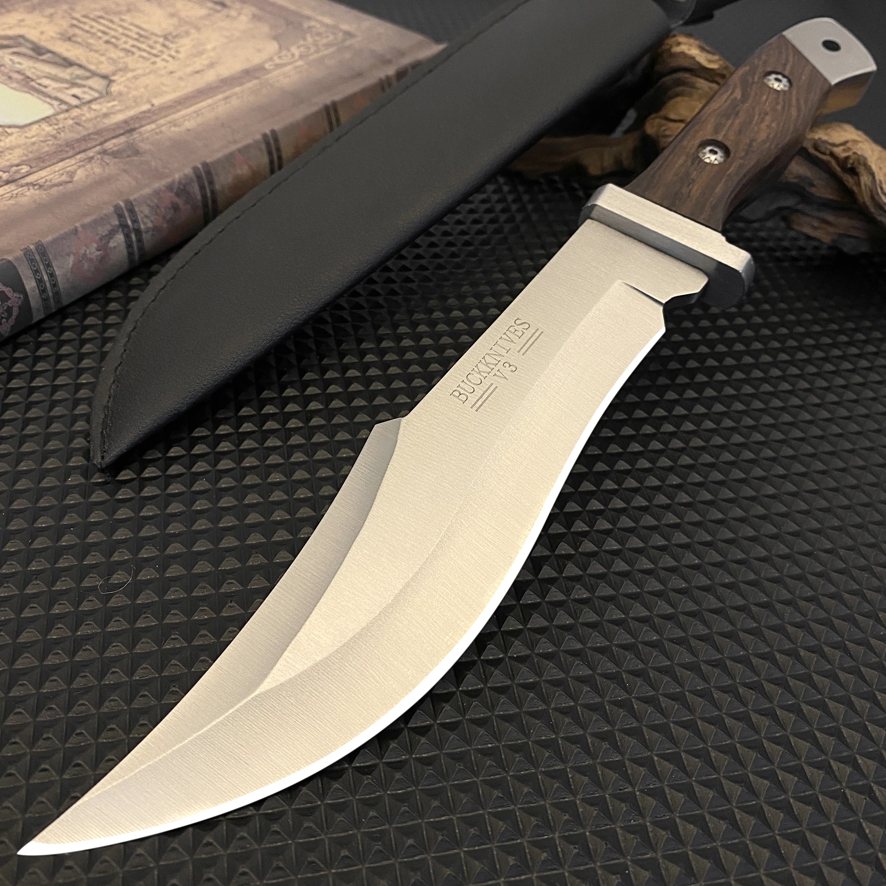 Stainless steel hunting knife with a wooden handle, paired with a black leather sheath, an essential tool for adventurers