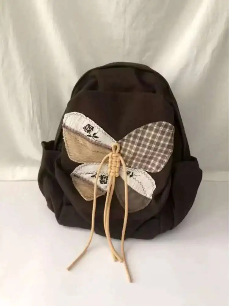 2025 ใหม่ Patchwork ผีเสื้อกระเป๋านักเรียนกระเป๋าเป้สะพายหลังไหล่กระเป๋านักเรียนวัยรุ่นของขวัญ B1979 hit